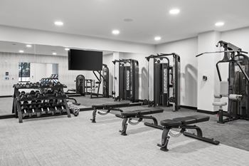 a gym with weights and a tv in a building